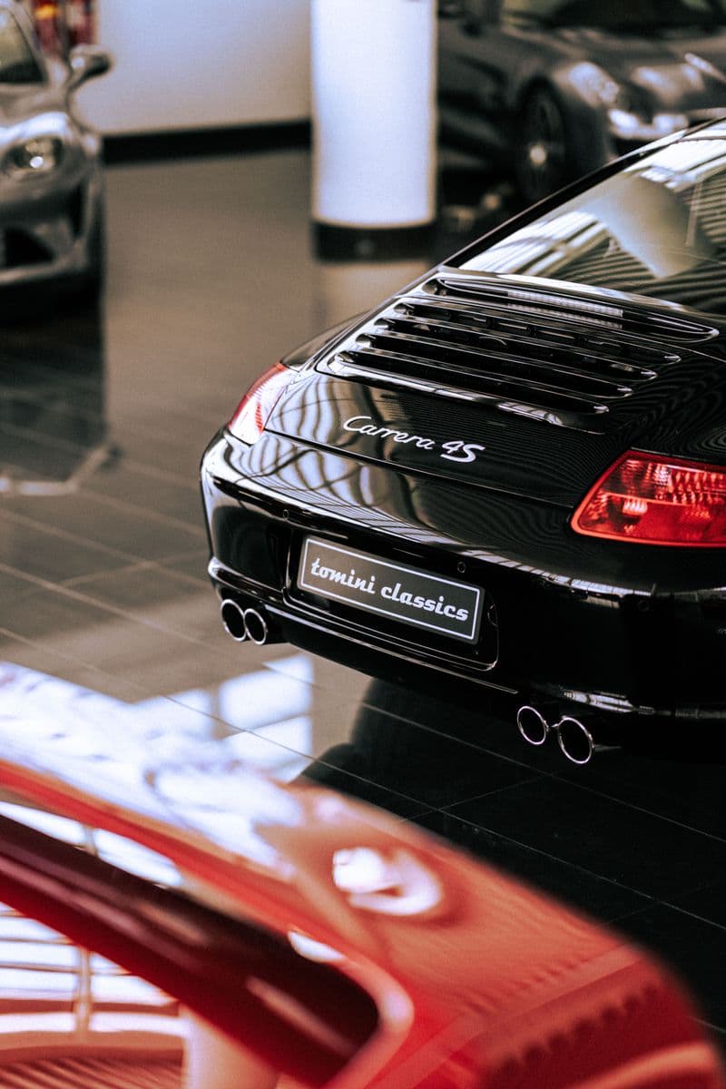 Detail of a black Porsche Carrera 4S photographed in a car collection